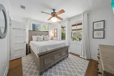 A bright, restful guest bedroom with a queen bed and its own private ensuite, set just off the kitchen.
