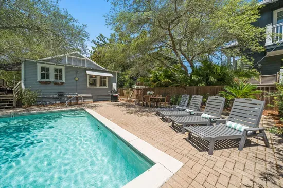 A waterfall feature and tanning ledge make the pool as relaxing as it is fun, framed by lush landscaping for a private feel.