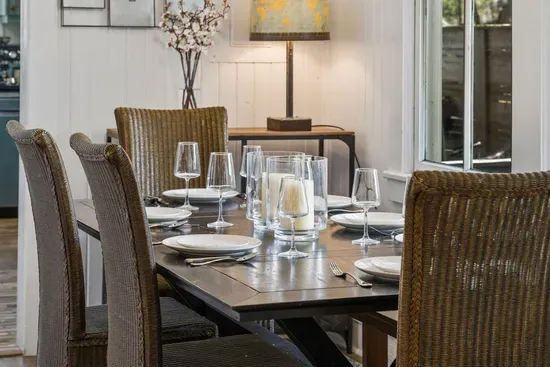 The indoor dining table sits just off the kitchen with seating for six, perfect for family meals together.