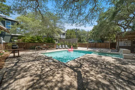 A roomy paver patio wraps the pool with sun loungers and plenty of space to spread out between dips.