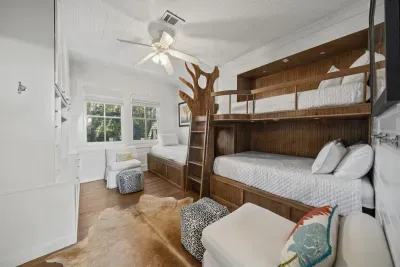 The kid-favorite bunk room sleeps the whole crew with a double, a twin bunk above, and a twin with trundle — rustic charm plus its own ensuite bath with a tub.