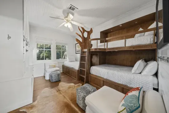 The kid-favorite bunk room sleeps the whole crew with a double, a twin bunk above, and a twin with trundle — rustic charm plus its own ensuite bath with a tub.
