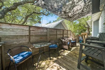 Just off the kitchen, a shaded back deck with ample seating is the perfect spot for morning coffee or an after-beach drink.