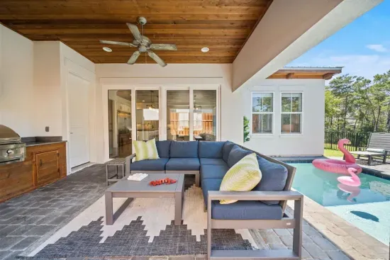 Grill dinner while the kids swim, then move to the sectional for the game on the outdoor TV — the covered patio does it all.