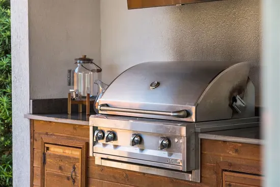 The Artisan 3-burner propane grill is built in and ready to go — a proper outdoor cooking setup for families who like to eat well on vacation.