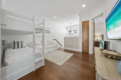 A built-in hangout with its own TV, sofa, and bunks — the kids can decompress here after a day at the beach