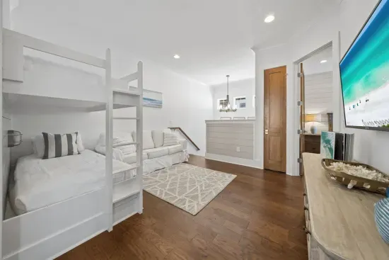 A built-in hangout with its own TV, sofa, and bunks — the kids can decompress here after a day at the beach