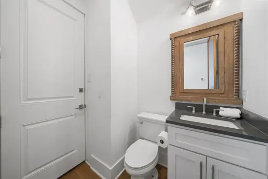 A convenient half bath on the main level with direct pool access — guests can rinse and refresh without tracking through the living space.