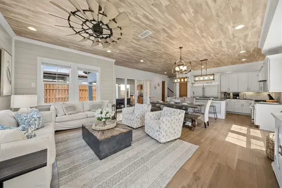 Mornings start here with coffee at the island, afternoons spill out to the patio, and evenings gather around the 65" TV — the heart of the home.
