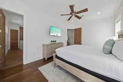 The master suite has everything — 55" TV, walk-in closet, and a private en-suite bath, tucked away at the end of the hall for a true retreat feel.