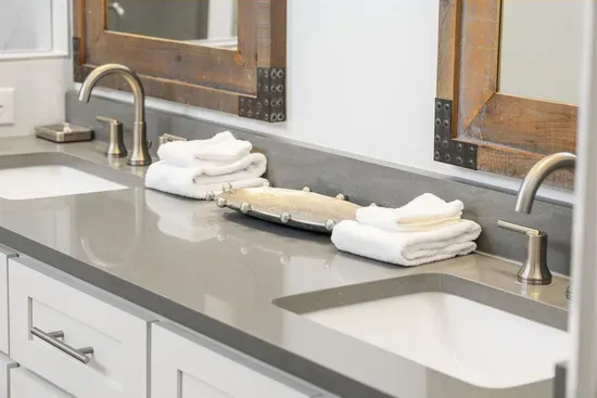Dual sinks, fresh towels, and riveted wood-frame mirrors — the master vanity gives everyone their own space to get ready.
