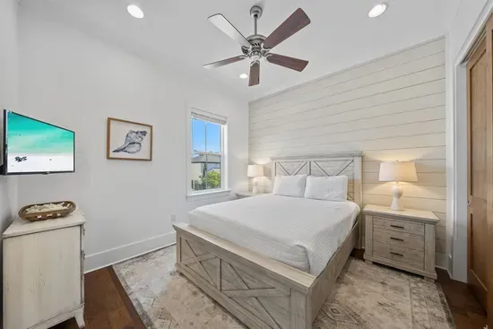 A beautifully styled bedroom that shares a bath with the adjacent room — ideal for two couples or older kids who want their own space.
