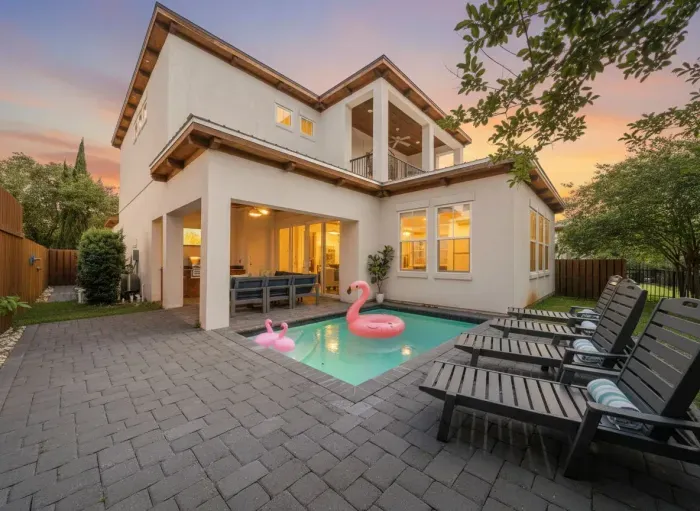End your beach days here — the heated pool glows at dusk, flamingo floaties are waiting, and the outdoor kitchen is steps away. This is what vacation looks like.
