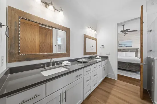 A wide dual vanity shared between bedrooms — plenty of counter space so no one is rushing through the morning routine.