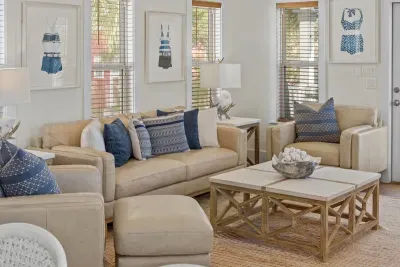 Soft neutral sofas, blue accent pillows and a big coffee table make this living area ready for family time.