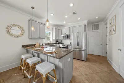 The kitchen has granite countertops, stainless steel appliances and an island with three stools, so the cook is never alone.