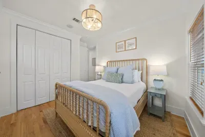 A cozy wooden bed with soft blue linens and a roomy closet make this bedroom a comfortable place to land.