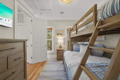 Bunk beds with a ladder and a bright window give the kids their own hangout.