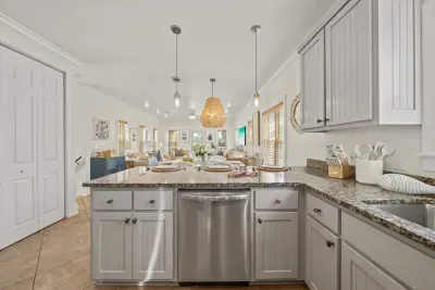 The fully equipped kitchen has stainless steel appliances, a dishwasher and plenty of counter space for family meals all week.