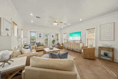 Sink into the sofas after a beach day. The living room flows into the dining area and kitchen, so nobody misses a moment of the conversation.