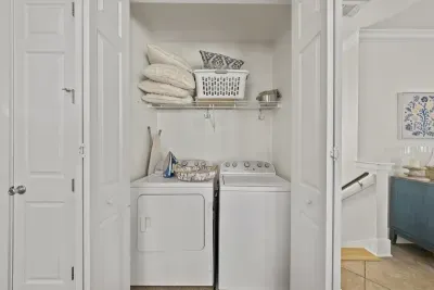 A full size washer and dryer are tucked into a handy laundry closet, with extra linens close by for longer stays.