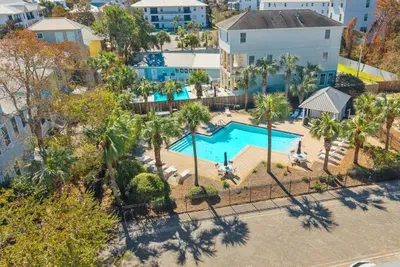 From above, the community pool and landscaped deck sit just beyond the home, a short stroll from your front door.