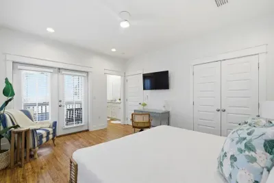 Primary bedroom with seating area and access to natural light