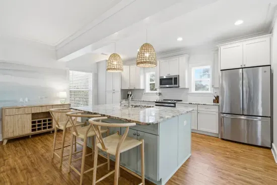 Kitchen and dining area with stainless appliances and ample seating