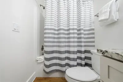 Bathroom with tub/shower combo and fresh, clean finishes