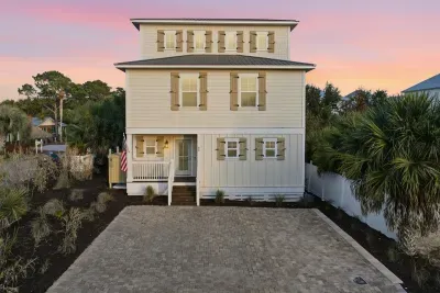Front exterior of the home with private parking pad that can fit 4-6 cars