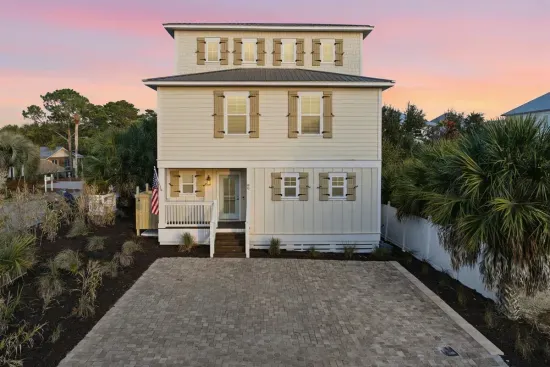 Front exterior of the home with private parking pad that can fit 4-6 cars