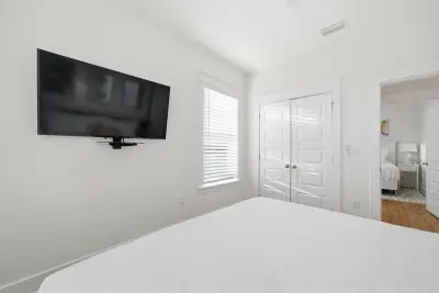 Guest bedroom with wall-mounted TV and private feel