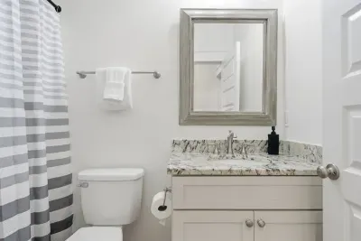3rd floor Bathroom with granite vanity and tub/shower combination