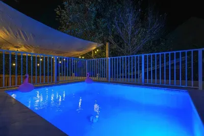 Private pool with ambient evening lighting and safety fence. Perfect for relaxing swims after sunset.