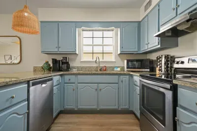 Fully equipped kitchen with stainless steel appliances, ample counter space, and all the essentials for preparing meals during your stay.