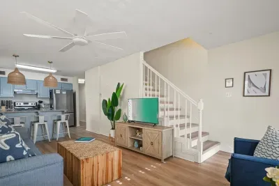 Open-concept living space with a seamless flow between the living area, kitchen, and stairs—ideal for gathering, entertaining, and relaxing together.