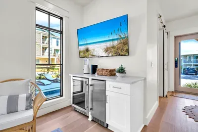 A beverage fridge, an ice maker, and a blender right by the pool door. Cold drinks and frozen ones without a trip upstairs.