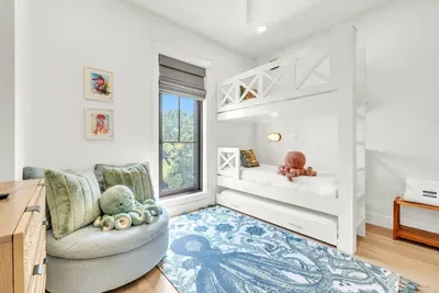 The kids will pick this room before you finish the tour. Built in bunks with a trundle underneath, a swivel cuddle chair, and an octopus rug on the floor.