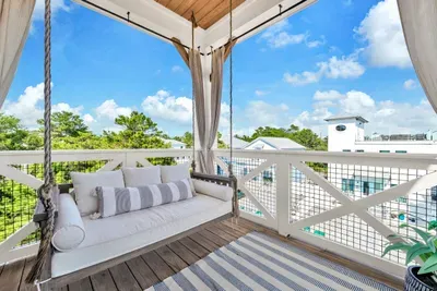 The porch swing bed. Draw the curtains, stretch out, and let the neighborhood go quiet around you. Easily the most fought over seat in the house.
