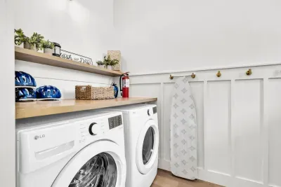 A full size washer and dryer with a folding counter above and hooks for damp towels. Pack lighter, run a load midweek, head home with clean clothes.