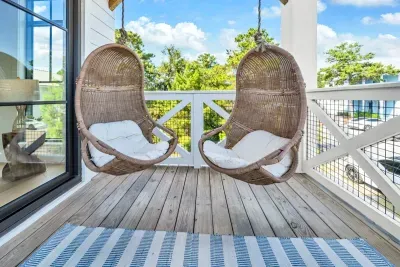 Two hanging chairs on a private balcony, level with the treetops. Coffee in the morning, a book in the afternoon, and nobody bothering you either way.