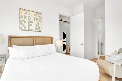 You, me and the sea. A cane bed, crisp white linens, and both a bath and the laundry closet just outside the door.