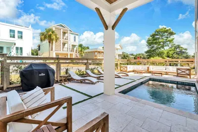 Gas grill on one side, loungers on the other, pool in the middle, and shade when you want it. Dinner outside is the default here.