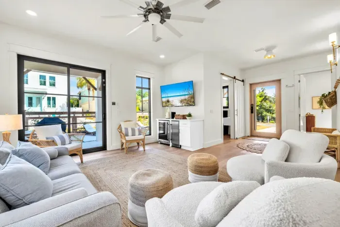 This level opens straight onto the pool deck, so wet feet and towels never have to cross the whole house. Sink into the boucle swivel chairs with the game on and the sliders open.