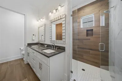 Double sink vanity with plenty of counter space — no sharing, no waiting. 1st floor bedroom