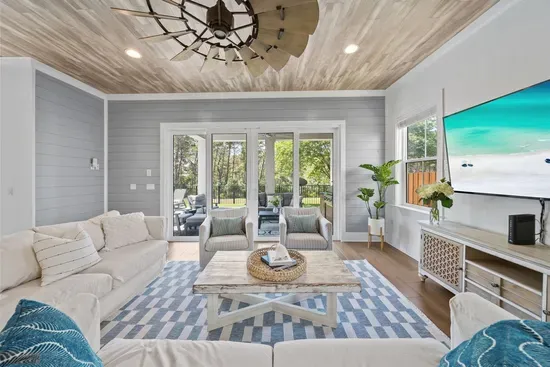 Two sofas, two swivel chairs, a 65" TV, and a coastal vibe that feels like vacation the moment you walk in.