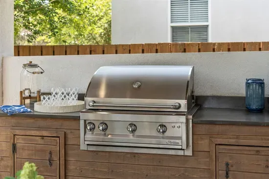A fully equipped outdoor kitchen with a gas propane grill — sunset dinners just got an upgrade.