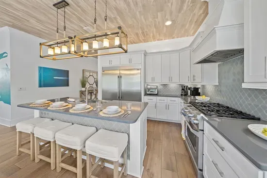 Chef's kitchen with oversized island seating, gas range, and everything you need for a full week of family meals.