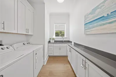 A dedicated laundry room with washer, dryer, and utility sink — everything you need for longer stays.