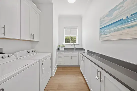 A dedicated laundry room with washer, dryer, and utility sink — everything you need for longer stays.